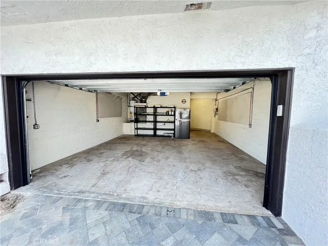 2+ Car garage with floor shelving storage as well as overhead storage.