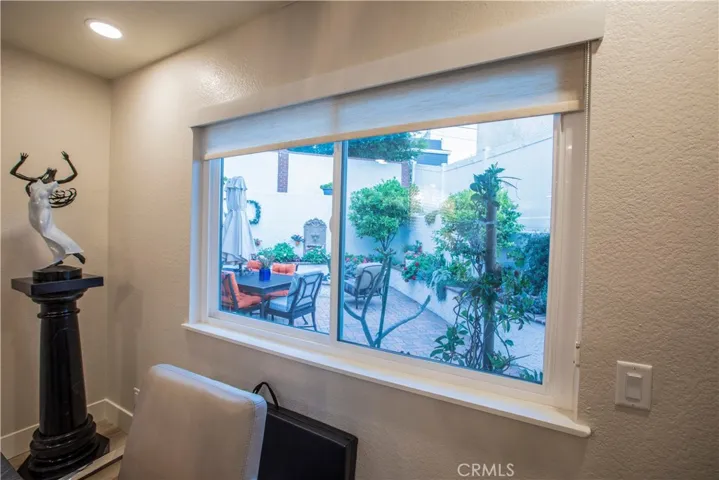 Window in the dining room with views of the beautiful patio area with firepit, water feature and outside BBQ area