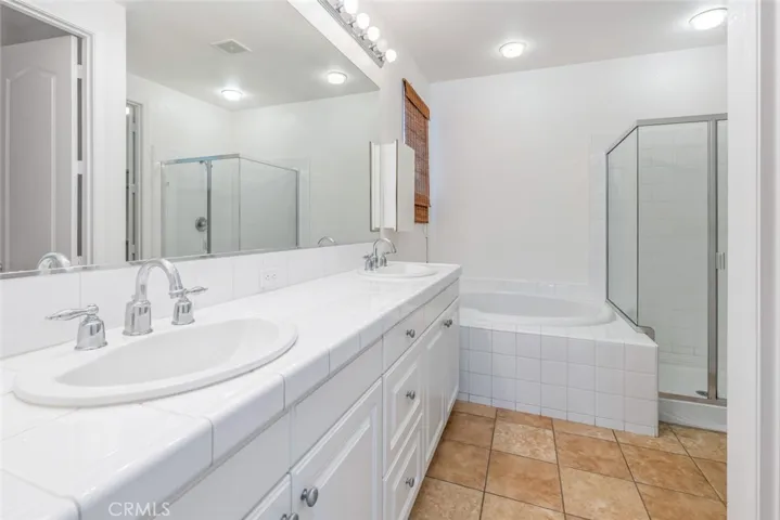 The primary bathroom is a retreat with dual sinks and a separate tub and shower.