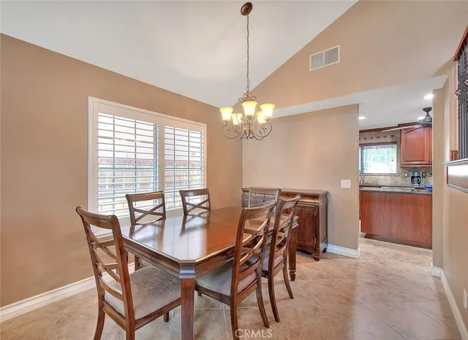 Upgraded chandelier, tile floor, and wood shutters