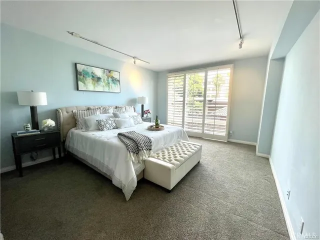 Primary bedroom with window shutters