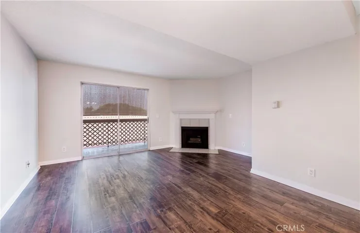 Living Space with Fireplace and under stair storage and inviting patio