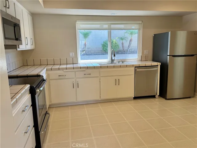The sunny and bright kitchen overlooks the backyard andhas a new dishwasher, new refrigerator and new garbage disposal.