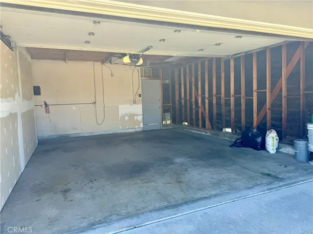 The interior of the two car garage with access to the backyard.