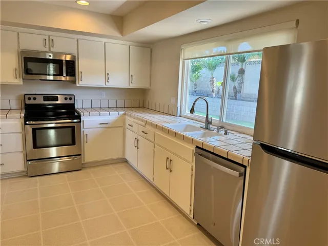 All stainless steel appliances in the kitchen.
