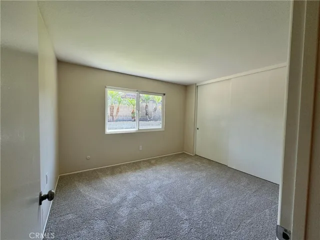 Bedroom #4 has a view of the backyard, new carpet, fresh paint, and oversized closets