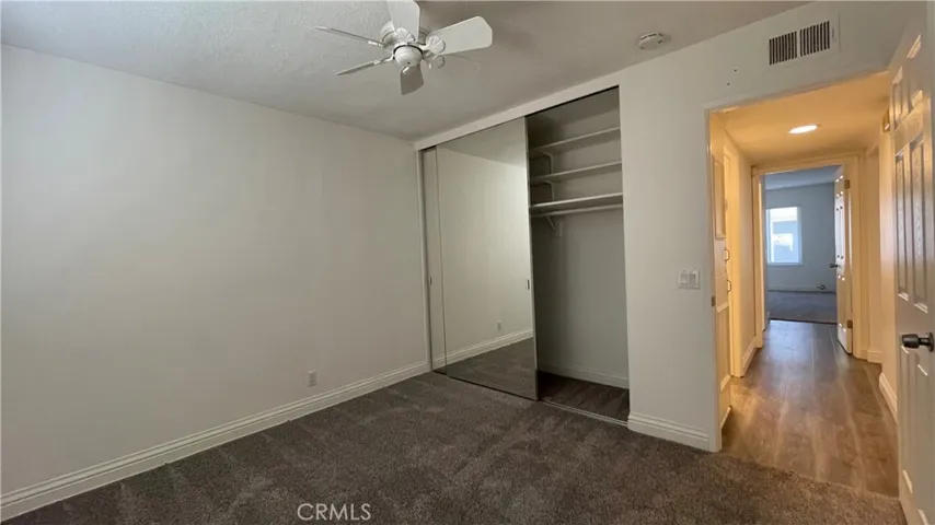 Secondary bedroom and hallway to primary bedroom