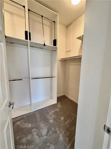 Primary Closet with HIGH Pull Down Bars