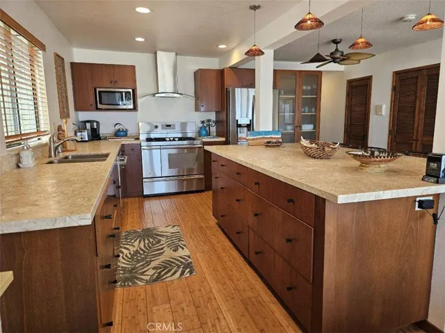 Custom Cabinets and Stainless Steel appliances.  There's quite a bit of room for kitchen/storage items with custom built-in shelving right next to the refrigerator.