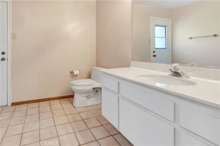 Powder Room Downstairs Includes Shower Stall Accessible to People Enjoying the Pool