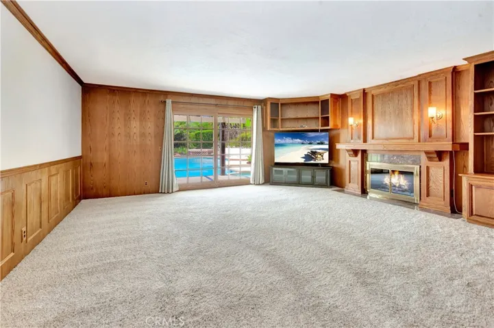 Family Room Showing Wall (to left) Separating FR from Kitchen, plus French Doors Leading to Pool and Backyard
