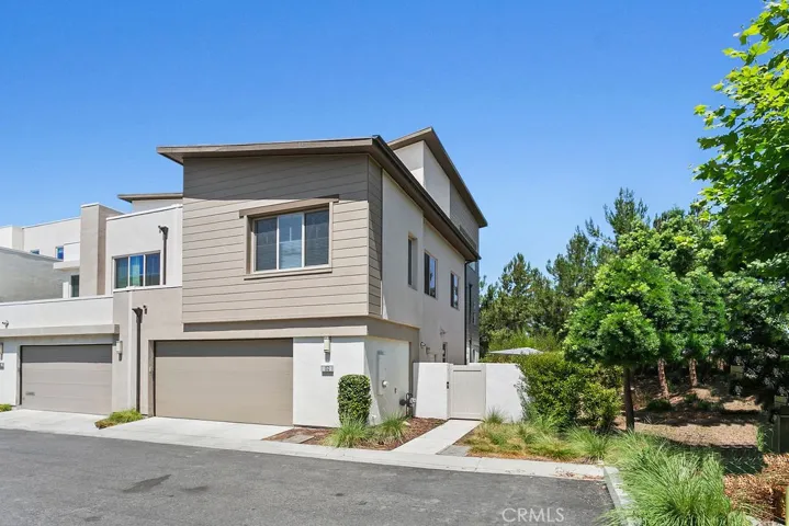 Back entry of home (2-car attached garage + side gate entry)