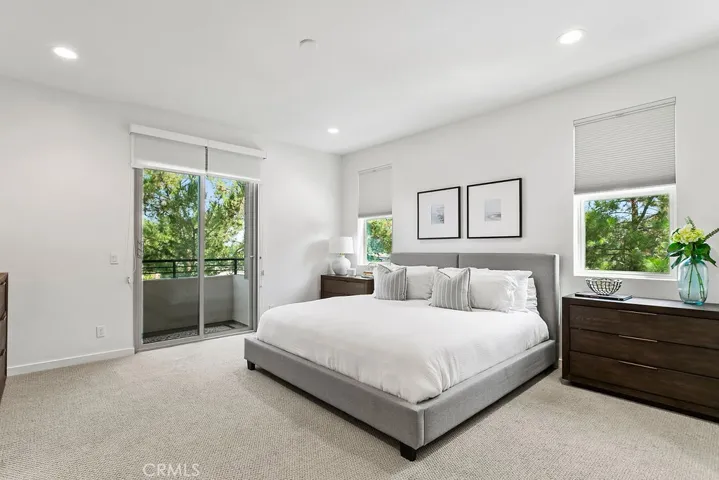 Primary suite with Juliette balcony & custom window treatments