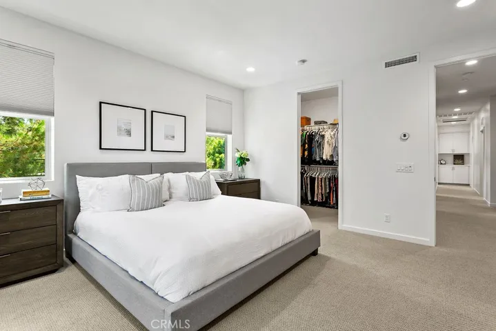 Primary suite is flooded with natural light & features large walk-in closet
