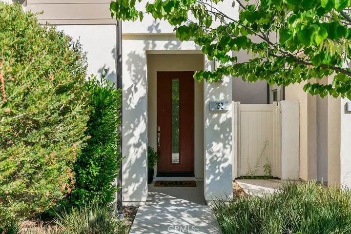 Welcoming front covered entry with natural landscaping