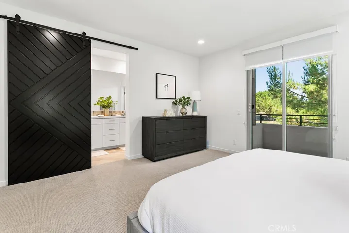 Primary bath is accessed through stunning custom-built slider door