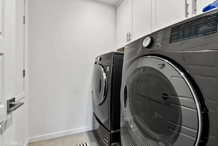 Individual laundry room with overhead cabinetry