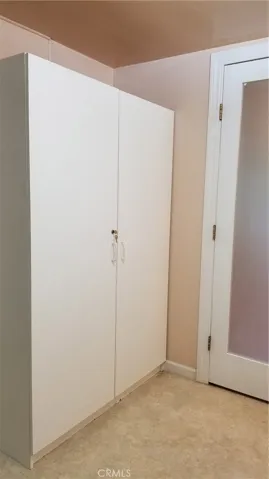 Inside bathroom. Large storage cabinet.