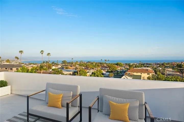 Roof Top Deck with expansive panoramic White Water Ocean View Photo has been virtually staged