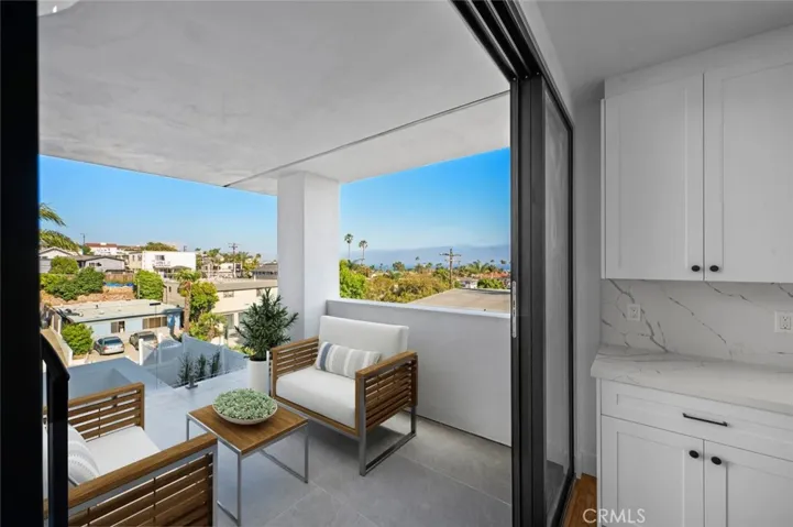Indoor Outdoor living on your private patio that has a Panoramic Ocean-view Photo has been virtually staged