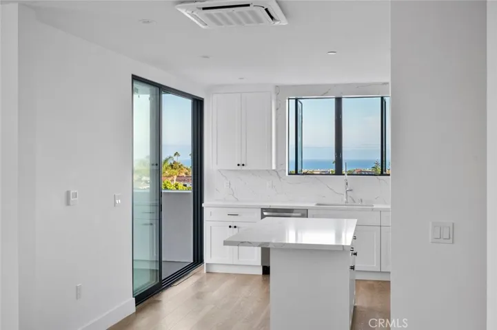 Ocean View from inside the living and kitchen area. Kitchen has stainless steel appliances and a center island.
