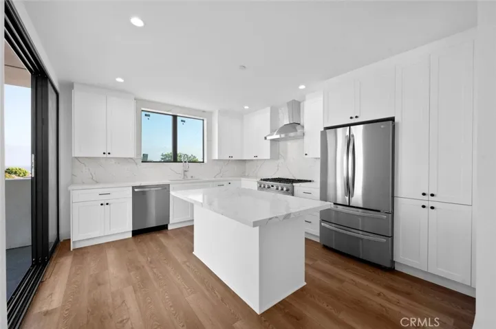 Ocean View from inside the living and kitchen area. Kitchen has stainless steel appliances and a center island.