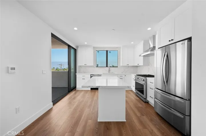 Ocean View from inside the living and kitchen area. Kitchen has stainless steel appliances and a center island.