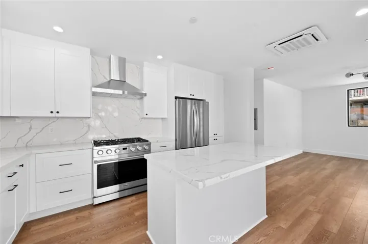 Ocean View from inside the living and kitchen area. Kitchen has stainless steel appliances and a center island.