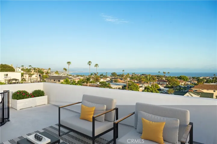 Roof Top Deck with expansive panoramic White Water Ocean View Photo has been virtually staged