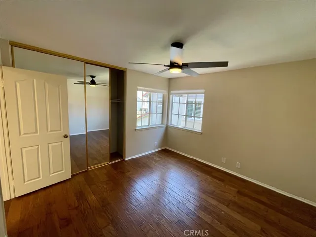 The third bedroom with mirror closet doors, two windows and a NEW ceiling fan with LED light.