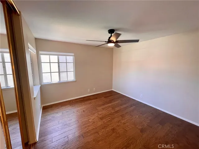 The third bedroom with mirror closet doors, two windows and a NEW ceiling fan with LED light.