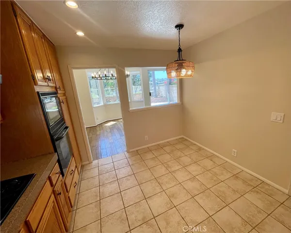 The kitchen features a separate eating area with NEW light fixture.
