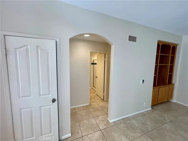The hallway leading to the downstairs bathroom (with a shower!) and the laundry room / garage.