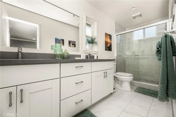 Primary Suite Bath with Double sinks, Shower only (tub removed) Tile Flooring