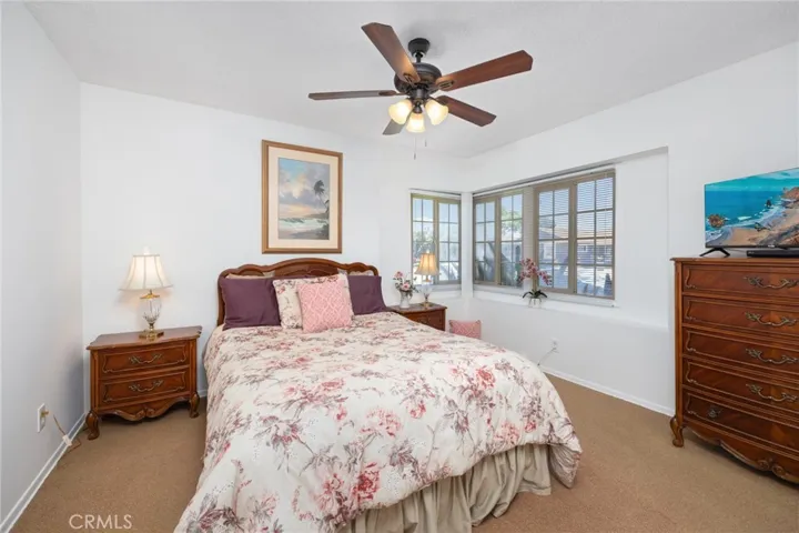 Primary bedroom has corner windows that overlook the beautiful landscaping.