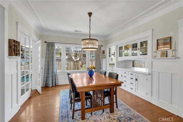 Formal dining room with original built-in buffet and French doors leading to the sunroom/office.