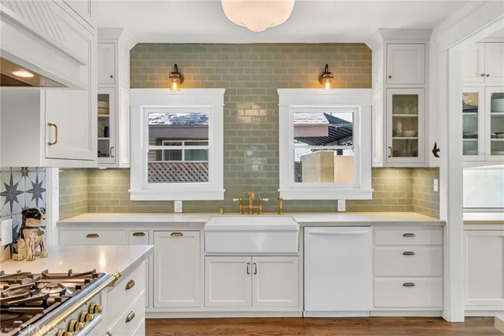 Remodeled kitchen with white carrera quartz counter tops, dishwasher, farm sink, and all new custom cabinetry.