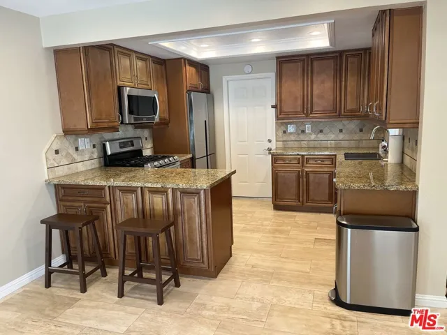 Kitchen is clean and open to dining