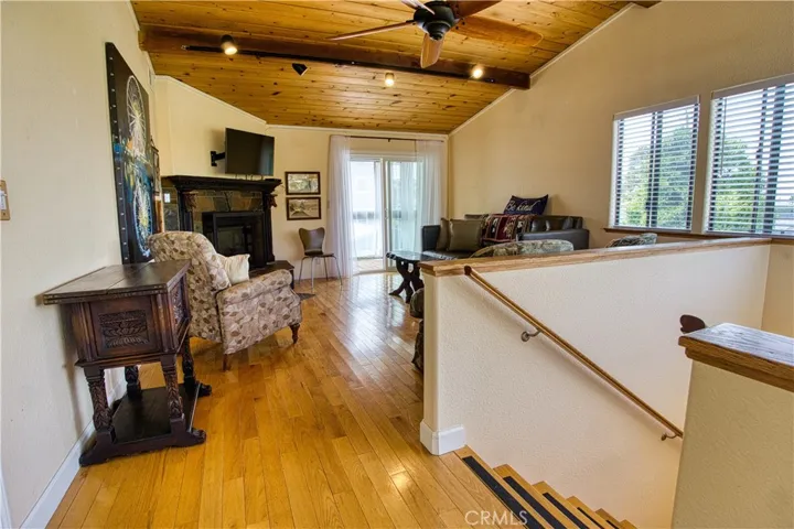 Upper level livingroom with fireplace, balcony and view of Morro Rock.