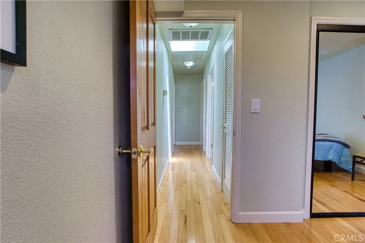Hallway from secondary bedroom to upper level bathroom, 3rd bedroom and stairway.