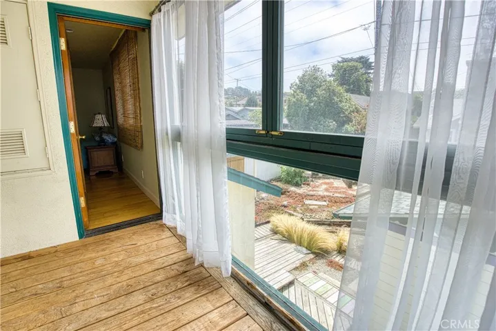 Enclosed balcony from living room with transom windows for ocean breezes