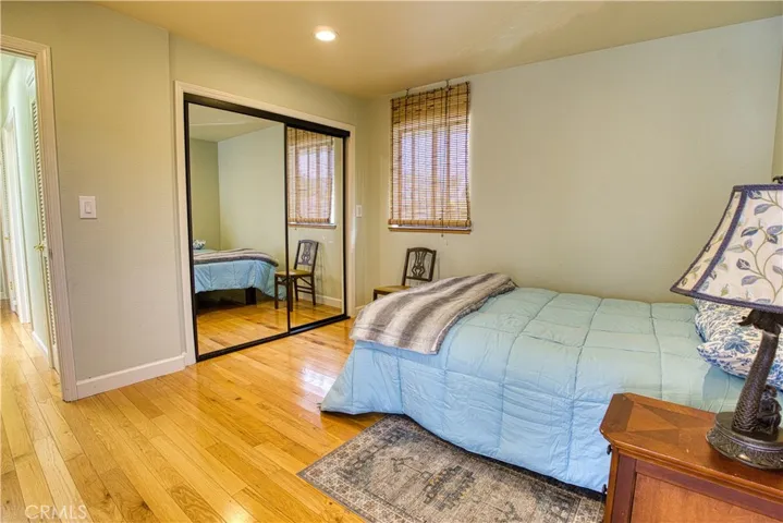 Secondary bedroom with wardrobe mirrored closet and closet organizer shelving