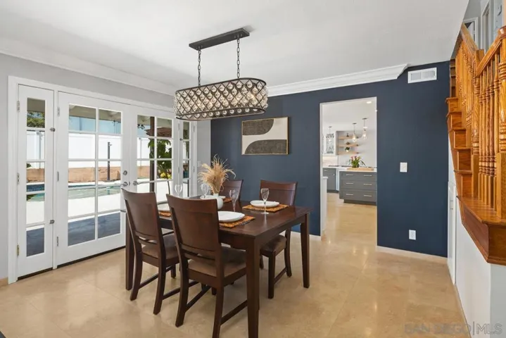 Formal dining room with nice open concept leading out through double doors, pool area. Perfect spot for entertainment.