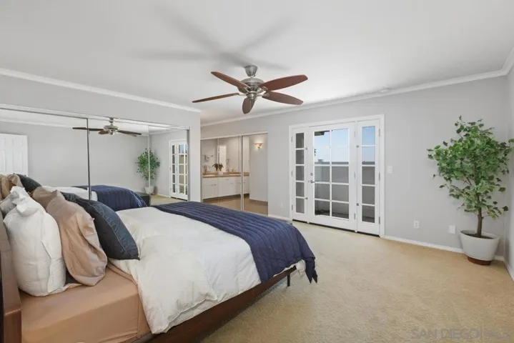 Large primary bedroom located on first floor with views looking out on city lights through your glass double doors, two full closets and attached primary bathroom.