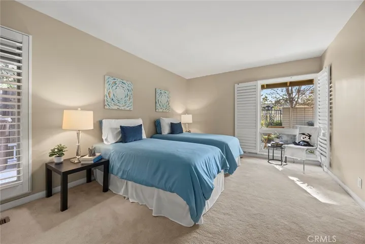 Bedroom #3 is another light and airy room. This spacious bedroom has enough room for two beds. It has multiple windows with built in wood shutters.