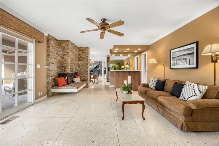 The family room is an inviting space designed for relaxation and entertainment, blending style and functionality.  Terrazzo flooring not only enhances the room's aesthetic appeal but also provides easy maintenance, perfect for a lively family environment.