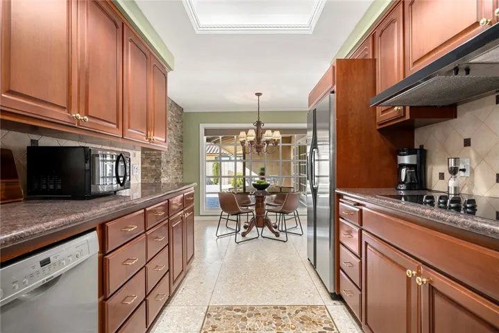 Updated kitchen has wood cabinets, granite counters, tile backspace, stone flooring and stainless steel appliances. It will inspire your inner chef.