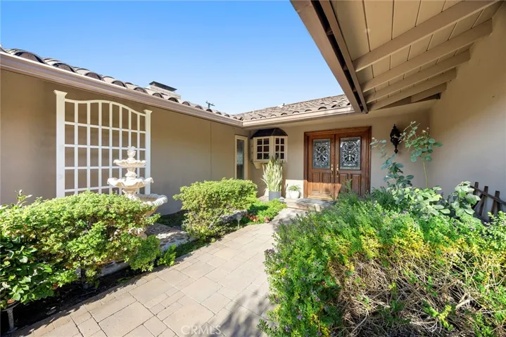 Upon arrival, substantial wood doors with leaded glass open to a lovely home with large picture windows throughout.
