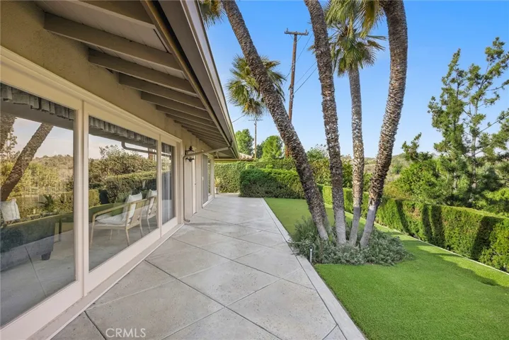 The backyard is beautifully manicured with grassy space for outdoor play and relaxation.