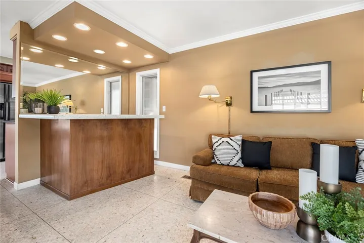 A standout feature of this rooms is the built-in bar. The bar area serves as a natural gathering spot, ideal for entertaining guests or enjoying a casual evening with the family.